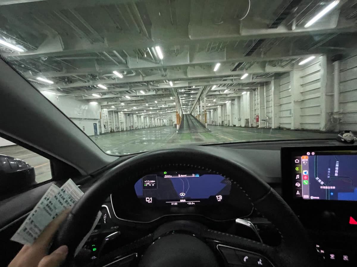 A vehicle being driven along the vehicle deck inside a RoRo vessel